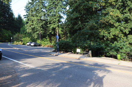One accessible parking space and bus stop at trailhead leading to Redwood Trail